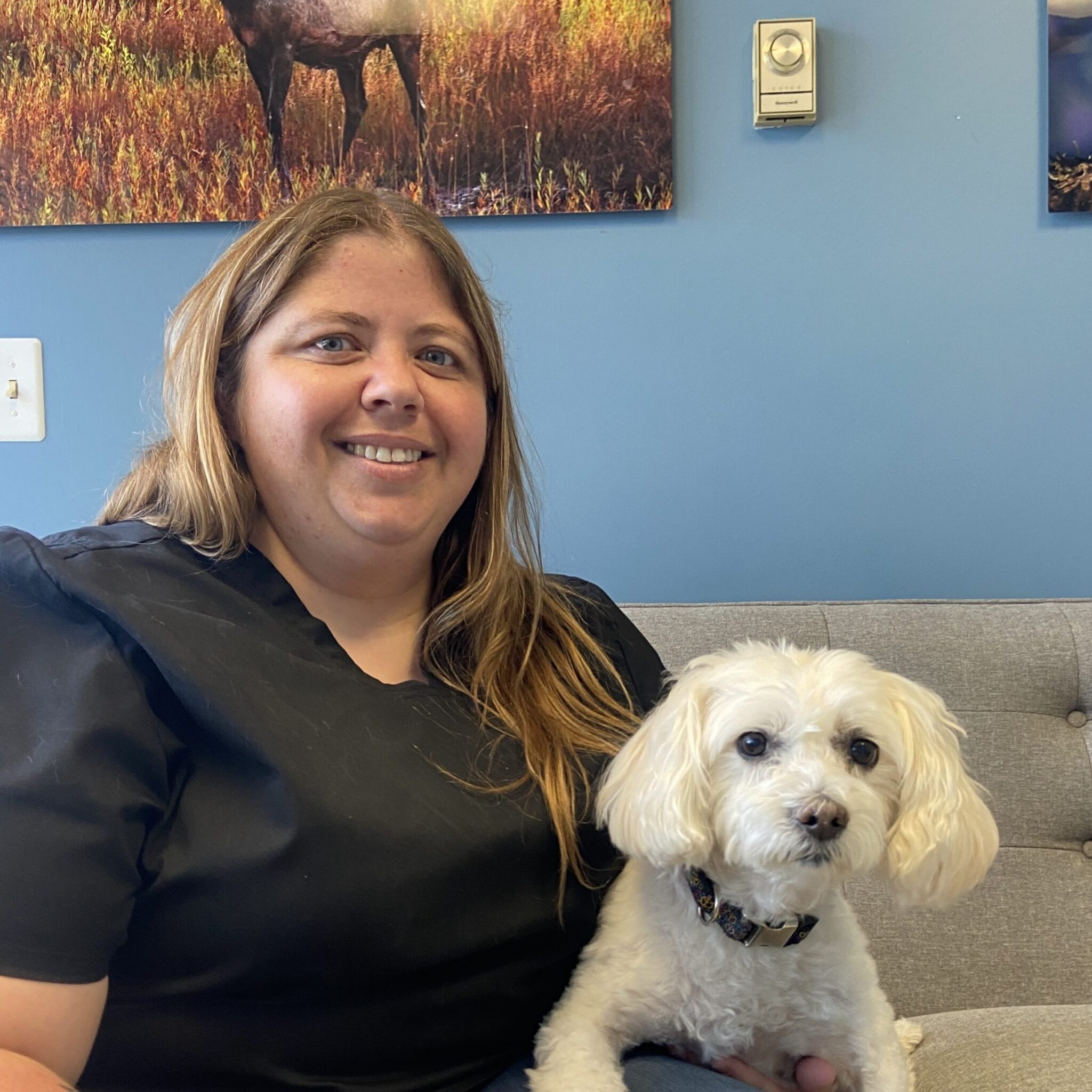 smiling woman with small white dog