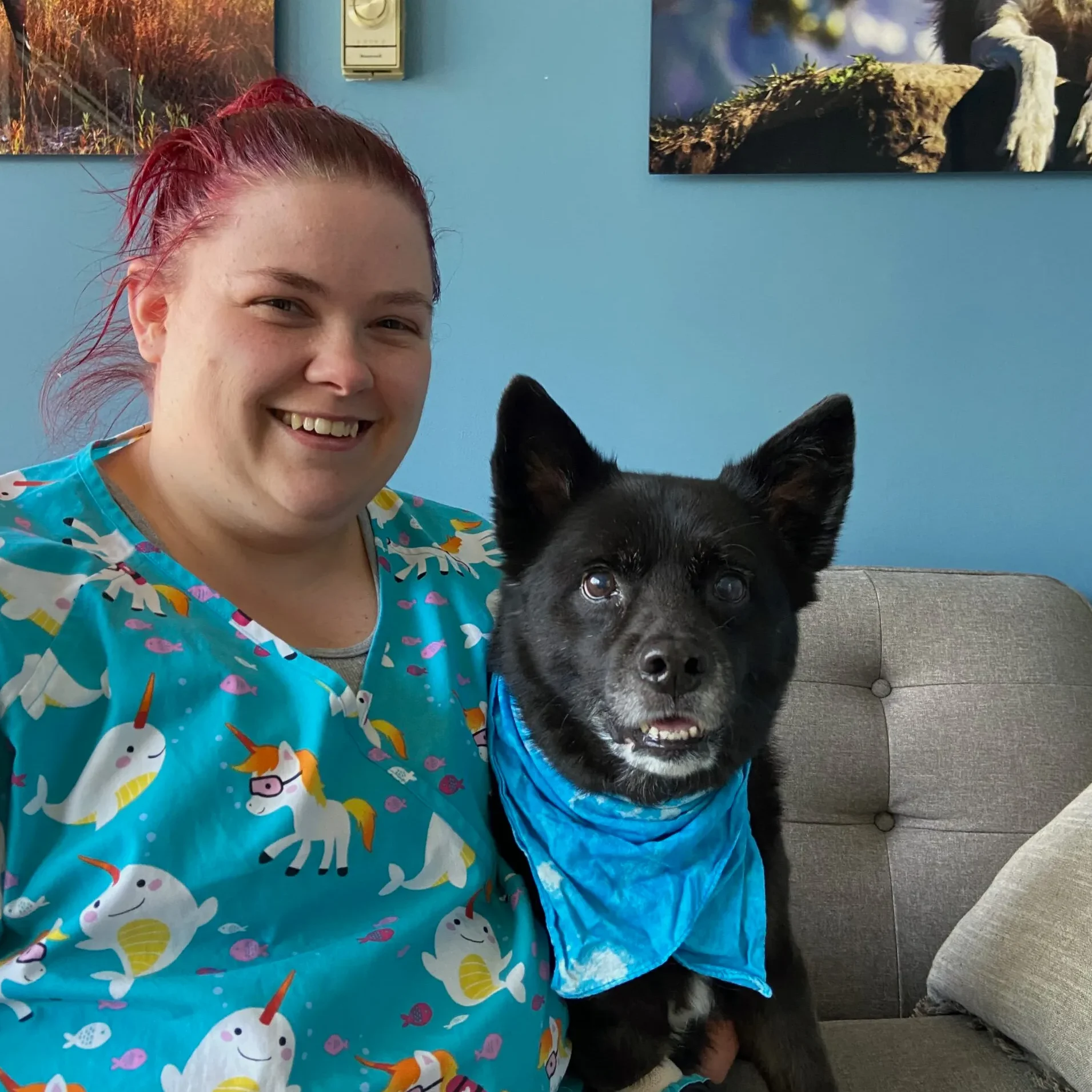 smiling red haired woman with a black dog